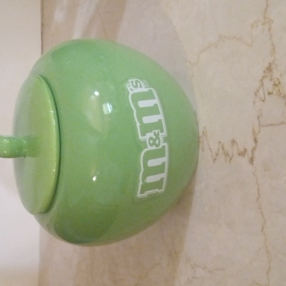 A M&M green canister. It can hold a variety of things. Cookies, Candy, Keys. - Picture 2 of 6
